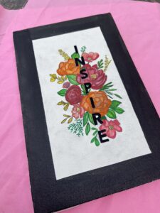 Canvas art featuring a hand embroidered inspired quote decorated with colour full flowers
