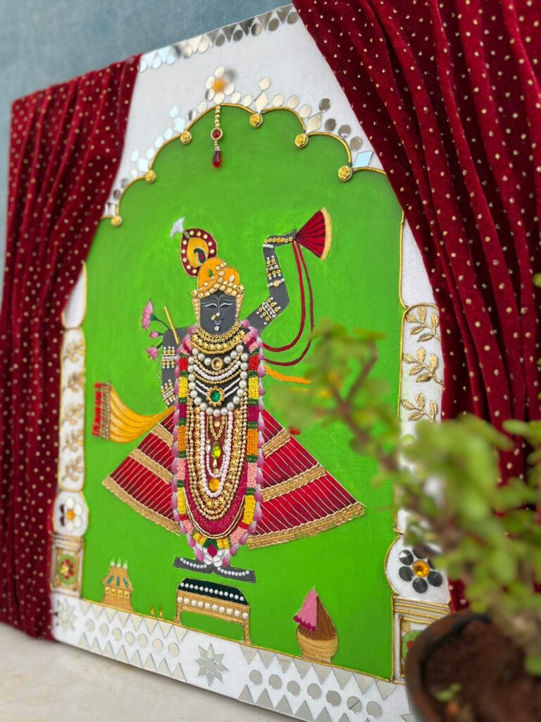 Handcrafted Pichwai painting of Lord Shreenathji adorned with intricate beadwork, fabric detailing, and traditional motifs.